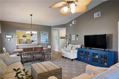 Carpeted living room with ceiling fan with notable