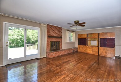 The entry hall opens to the den w/ gas log firepla