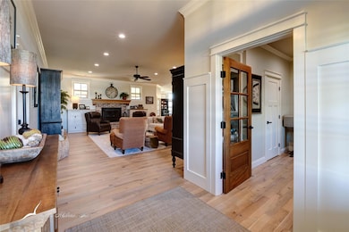 Living room featuring ceiling fan, light hardwood 