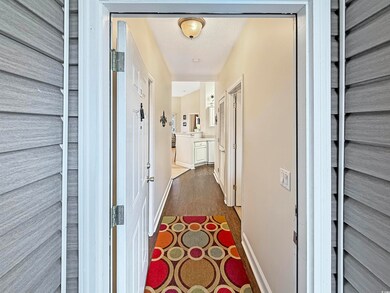 Hallway featuring a textured ceiling