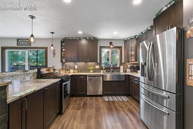 Kitchen featuring dark brown cabinets, appliances with stainless steel finishes, light stone counters, dark wood finished floors, and recessed lighting