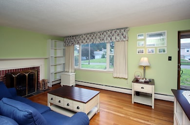 living room area/ hardwood flooring/lg picture window