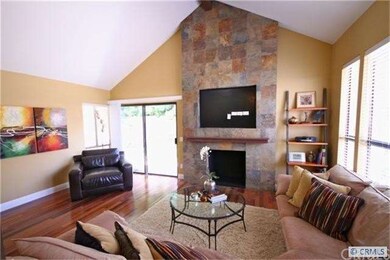 View of living room with custom fireplace.