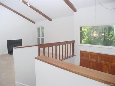 Living room has vaulted ceiling w exposed beams