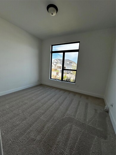 Spare room with baseboards and carpet