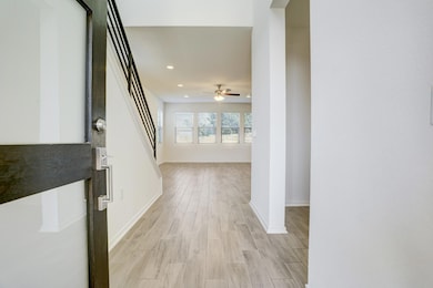 Corridor featuring wood finish floors and recessed lighting