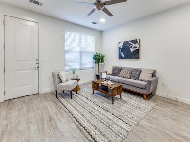 Living room with wood finished floors, visible ve
