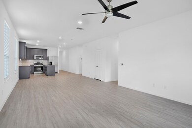 VIEW FROM FAMILY ROOM TO DINING & KITCHEN