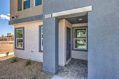 Doorway to property with stucco siding and fence