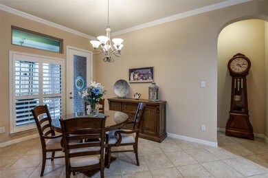 Tiled dining area with crown molding and a notable