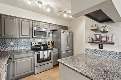 This gorgeous kitchen features stunning granite countertops and beautifully painted cabinetry.