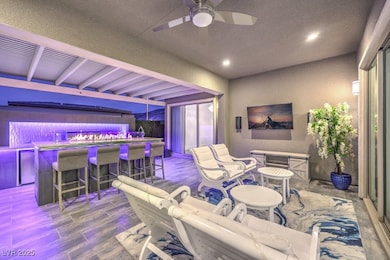 View of patio with outdoor dry bar and a ceiling f