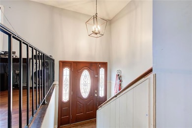 Entryway featuring wood finished floors, a towerin