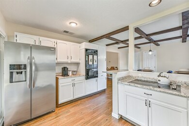 Spacious kitchen with granite counter tops, plenty of cabinetry and nice cooktop ~