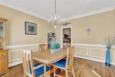 Dining area featuring a chandelier, ornamental mol