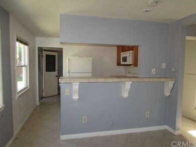 View of the kichen from the living room. Nice tile