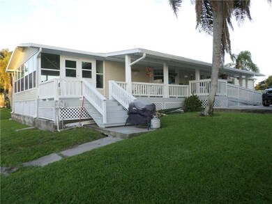 SIDE OF HOME WITH HUGE FLORIDA ROOM  OVERLOOKING T