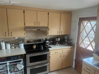 Kitchen with backsplash, light countertops, under 