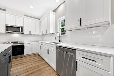 Stainless steel appliances, custom cabinetry, and modern hardware bring both function and flair to your cooking space.