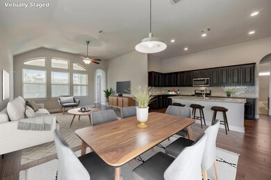Dining space featuring ceiling fan, lofted ceiling