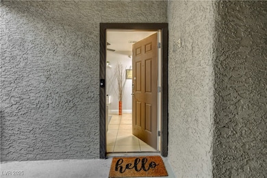 Doorway to property with stucco siding