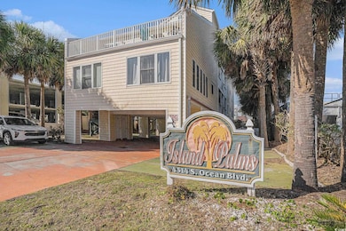 Community sign with a carport and driveway