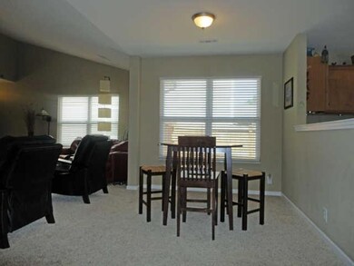 The convenient dining area is located between the living room and kitchen.
