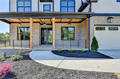 Doorway to property with brick siding, a porch, a 