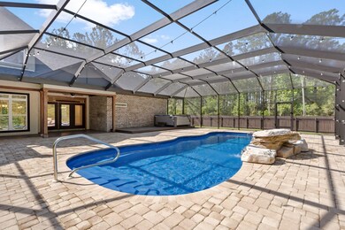 Enclosed inground pool with waterfall feature and