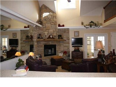 Vaulted ceiling and a stone wood burning fireplace