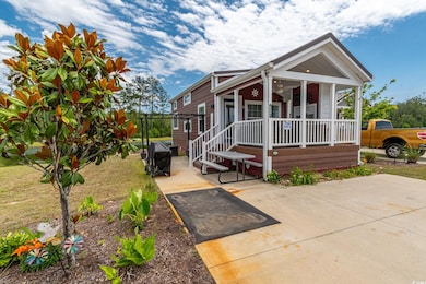 View of front of home featuring covered porch and a patio area