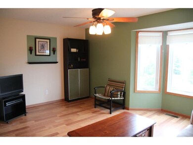 Sun-splashed main level living room with bay windo