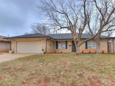 Ranch-style house featuring a front yard, a garage