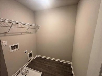 Laundry area with electric dryer hookup, washer hookup, and dark wood-style floors