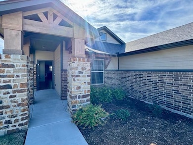 Entrance to property with a shingled roof