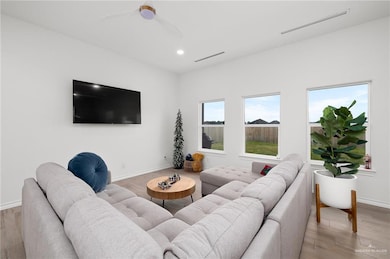 Living room featuring hardwood / wood-style floors and ceiling fan