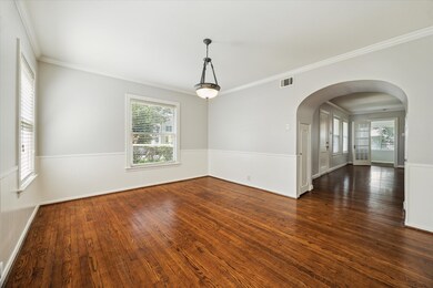 Spacious dining room features hardwood floors and
