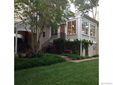 View of brick patio and rear of home.