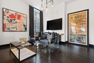 Sitting room with baseboards and hardwood / wood-style flooring