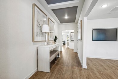 Hall with dark wood-style flooring and baseboards