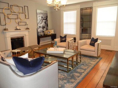 Parlor living room with wide plank floors and arti
