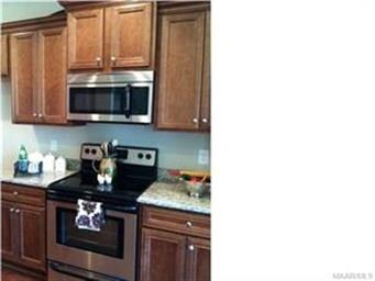 Stainless steel appliances and beautiful cabinets.