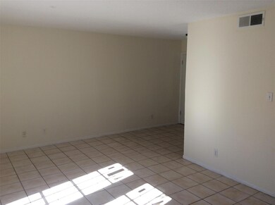 Unfurnished room featuring light tile patterned f