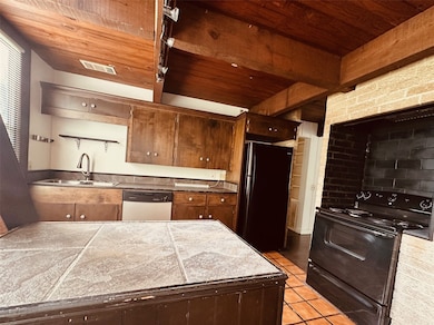 This kitchen features rustic wooden cabinetry and