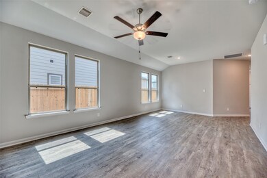 As you cross the threshold, you'll step into the spacious and inviting family room. Large double-paned windows room flood the space with abundant natural light, accentuating the warmth and charm of the interior.