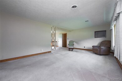 Spacious living room has wall to wall carpet - but for those who prefer hardwood flooring, you're in for a treat! Hardwood flooring is under the carpet in majority of the rooms.