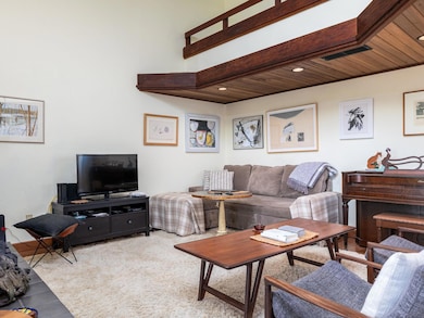 Living room with visible vents and wood ceiling