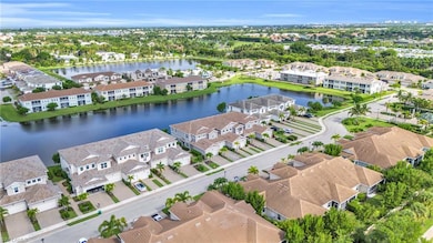 Aerial view of residential area featuring a nearby body of water