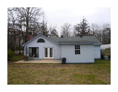 Exterior Back. Double french doors open onto large
