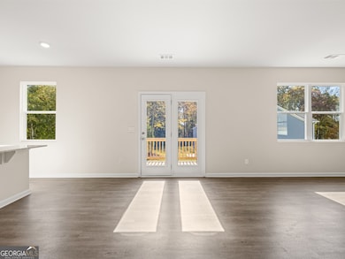 Sample Flora Living Room at Oaks at Cedar Grove in Fairburn, Georgia